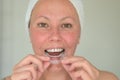 Woman suffering from bruxism holding a mouth guard Royalty Free Stock Photo