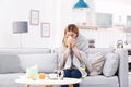 Woman suffering from cough and cold on sofa Royalty Free Stock Photo