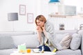 Woman suffering from cough and cold on sofa Royalty Free Stock Photo