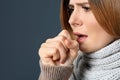 Woman suffering from cough on dark background, closeup. Royalty Free Stock Photo