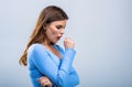 Woman is suffering with cough and feeling bad. Ill woman. Sick young girl coughing covering mouth with hand keeping Royalty Free Stock Photo