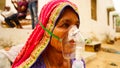 Woman suffering from Covid 19 disease. Old woman admitted in hospital and inhaling emergency oxygen with canula mask