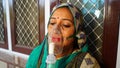 Indian woman infected with Covid 19 disease. Patient inhaling oxygen wearing mask with liquid Oxygen flow