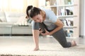 Woman suffering cramp practicing yoga at home