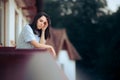 Woman Suffering a Headache Taking Fresh Air on the Balcony