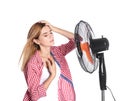 Woman suffering from heat in front of fan Royalty Free Stock Photo