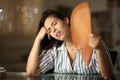 Woman suffering heat stroke fanning at home in the night Royalty Free Stock Photo