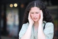 Woman suffering migraine complaining in the street Royalty Free Stock Photo