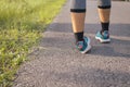 Woman suffering from pain ankle sprained on legs injury after sport exercise running jogging and workout Royalty Free Stock Photo