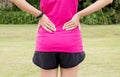 Woman suffering from pain in back injury after sport exercise running jogging and workout Royalty Free Stock Photo