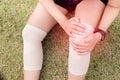 Woman suffering from pain in knee injury after sport exercise running jogging and workout Royalty Free Stock Photo