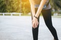 Woman suffering from pain in leg injury after sport exercise running jogging and workout outdoo,Hand touching her knee Royalty Free Stock Photo