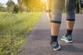 Woman suffering from pain in leg or shin injury after running jogging sport exercise and workout outdoor Royalty Free Stock Photo