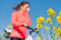 woman suffering from pollen allergy while training and riding bycicle outdoors