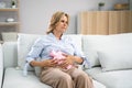 Woman Suffering From Stomach Pain While Lying On Sofa Royalty Free Stock Photo