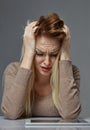 Woman suffering from stress or headache while being offended by pain, Royalty Free Stock Photo