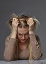 Woman suffering from stress or headache while being offended by pain, Royalty Free Stock Photo