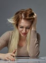 Woman suffering from stress or headache while being offended by pain, Royalty Free Stock Photo