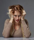 Woman suffering from stress or headache while being offended by pain, Royalty Free Stock Photo