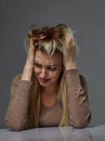 Woman suffering from stress or headache while being offended by pain, Royalty Free Stock Photo