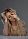 Woman suffering from stress or headache while being offended by pain Royalty Free Stock Photo