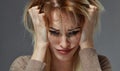 Woman suffering from stress or headache while being offended by pain, Royalty Free Stock Photo