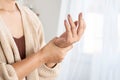 Woman suffering from wrist pain, numbness, or Carpal tunnel syndrome hand holding her ache joint Royalty Free Stock Photo