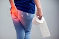 Woman suffers from diarrhea holds toilet paper roll. Stomach ups Royalty Free Stock Photo