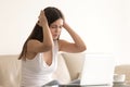 Woman suffers from headache during work on laptop Royalty Free Stock Photo