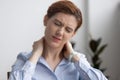 Woman suffers from neck pain while working at office