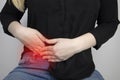 A woman suffers from pain in the appendix. Acute appendicitis, Crohn`s disease, or inflammatory bowel disease. Surgeon examinatio