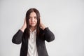 Woman in a suit, blocking her ears, business compliance concept Royalty Free Stock Photo