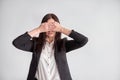 Woman in a suit, blocking her eyes, business compliance concept Royalty Free Stock Photo