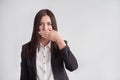 Woman in a suit, blocking her mouth, business compliance concept Royalty Free Stock Photo