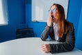 A woman in a suit and glasses makes yawns in the conference room. A female office manager with chronic fatigue sits at a Royalty Free Stock Photo