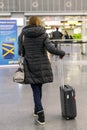 Woman with a suitcase at the airport. Selected focus