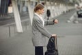 Woman with suitcase standing by the airport Royalty Free Stock Photo