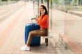 Woman With Suitcase Talking On Phone Waiting For Train Outside Royalty Free Stock Photo