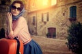 Woman with a suitcase travel on street of italian city Royalty Free Stock Photo