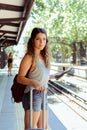 Woman with suitcase waiting the train Royalty Free Stock Photo