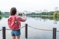 Woman in summer in city near lake, river pond, photographing landscape smartphone, recording video on Internet Royalty Free Stock Photo