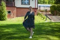 Woman in summer dress dancing on the green grass. Romantic girl dance on lawn. Carefree woman in the summer park outdoor. Summer Royalty Free Stock Photo