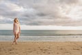 Woman in summer dress walking on beach