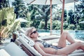 Woman Summer Fashion. Happy Girl With Fit Body, Long Legs, Healthy Skin In Bikini, Sunbathing By Swimming Pool On Royalty Free Stock Photo