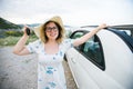 Woman in summer hat driver holding car keys driving her new car cabriolet - automobile and purchase concept Royalty Free Stock Photo