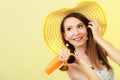 Woman in summer hat holds sunglasses sunscreen lotion