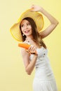 Woman in summer hat holds sunglasses sunscreen lotion