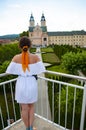 Woman in summer romantic dress at chapel castle travel destination. Summer castle and woman. Architectural landscape