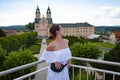 Woman in summer romantic dress at chapel castle travel destination. Summer castle and woman. Romantic view