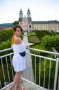 Woman in summer romantic dress at chapel castle travel destination. Summer castle and woman. Summer fashion
